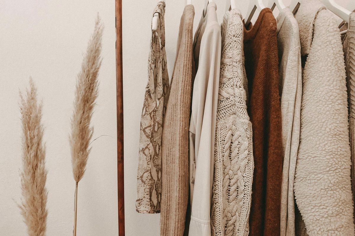 A curated clothing rail in a modern fashion retail environment.