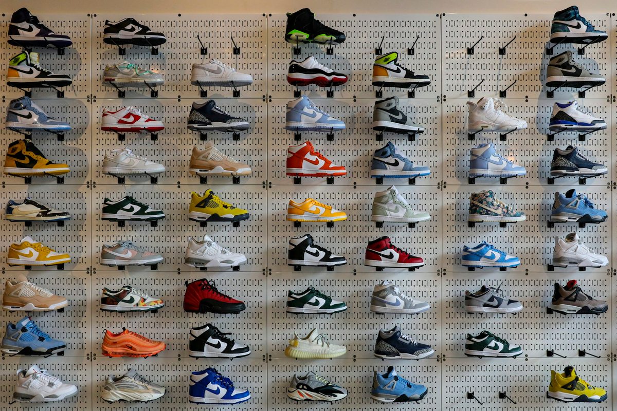 Footwear arranged on display shelves for retail category review.