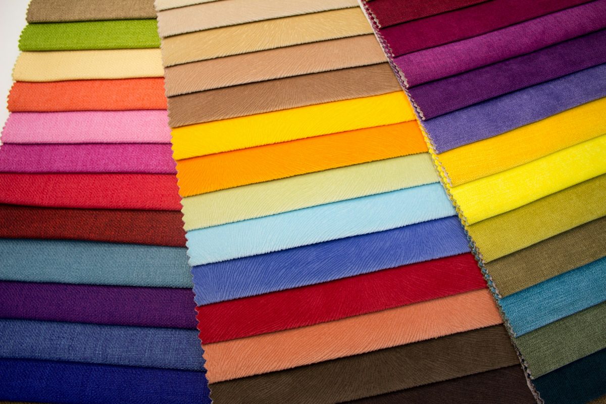 Trade sourcing desk with sample swatches and apparel notes.